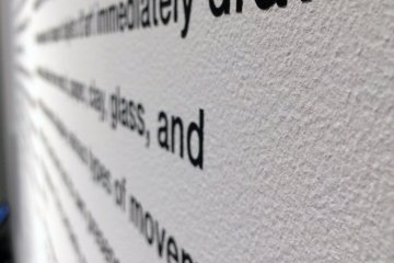 <p>Paragraphs of info. about Gehry are posted on the wall.</p>
