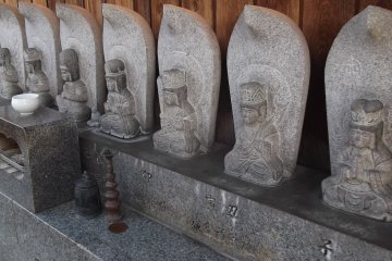 <p>Buddhist statues line up in welcome</p>
