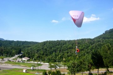 An advanced student begins a turn after taking off from the top of the intermediate hill