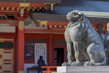 A Japanese lion-dog guards the entrance to the shrine
