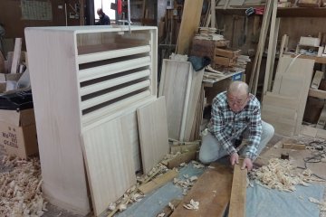 Another employee makes drawers and doors