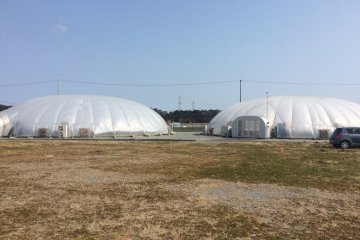 The greenhouses that use solar energy to grow the vegetables.