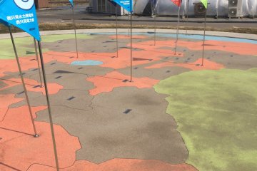 A fun map of each region in Fukushima, with the flags marking where solar energy production locations are in the area.