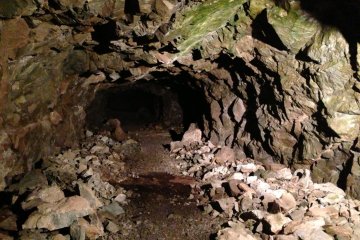 A tunnel closed to the public. Completely unlit and seemingly leading off into nothing.
