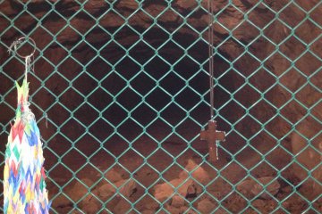 At the far end of the section of tunnel open to visitors, I found a cross and a number of paper cranes left by visitors as expressions of peace.