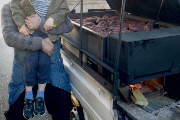 Checking out the wares, under the lid of an oven in the back of a mini truck
