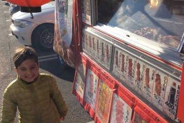 Barbecued, seasoned meat (mostly beef) on a skewer (kushiyaki) sold from the back truck in front of a local supermarket
