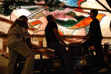 Local kids and teenagers play the taiko drums on the floats