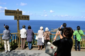 Visitors pause for pictures before deciding whether to head down to the coast.