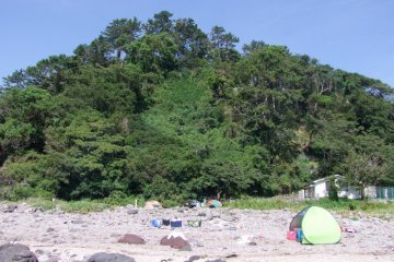A luscious forest, great for hiking, borders the shore