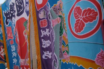 A town event, sparkling with the colorful flags of local fishing boats