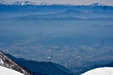 Mt. Fuji, Kitadake Peak, Japan's 1st and 2nd highest mountains, in the same shot. Kitadake Peak is the second peak to the left of Fuji. The city of Komagane stretches across the valley 2000m below (April)