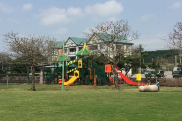 Children's playground in the middle of the lawn. 