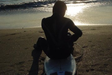 Surfer enjoying the sunset at Yuigahama Beach