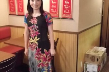 <p>The waitress in her colorful Vietnamese dress</p>