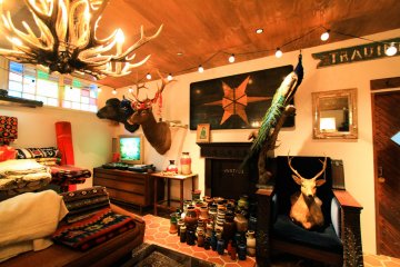 Carpets, pottery, deer heads, and various items for sale