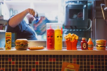 Quirky and retro deco in the restaurant; burger being grilled at the back