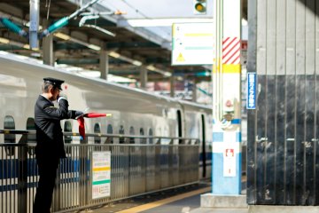 Officer giving signals for the train