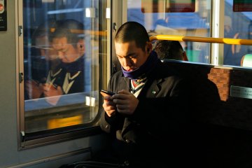 A high school student taking the train to school