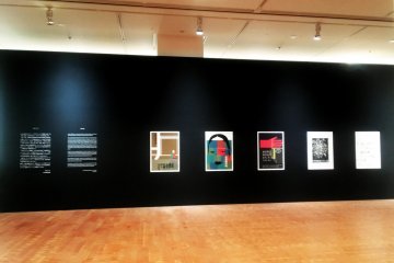The black walls show off the colourful posters to good effect