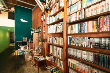 Piles of music, and book collections on shelves