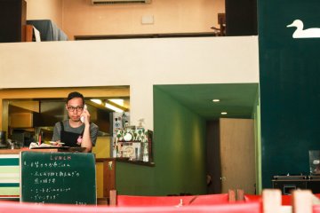 Cafe owner who manually roasts and grinds the coffee beans