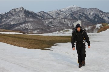 The author trekking with his paraglider on Heidi Hill in spring