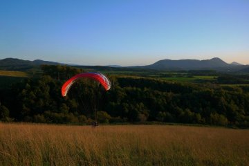 A paraglider pilot training in an unused field on Heidi Hill