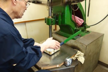 Hammering out gold foil by machine