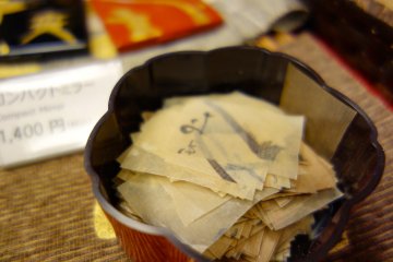 Sample squares of oil-blotting paper with traces of gold leaf