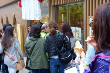 Curious passerbys and tourists crowd the popular store