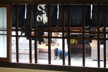 Ladies of competitor store, Kazariya, can be seen through the wooden slats