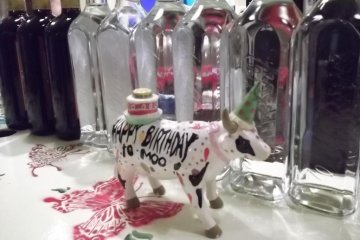 <p>A (non-pink) cow mooooching on the bar</p>