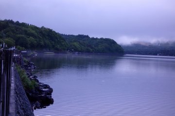 In addition to low-hanging clouds, mist and morning fog cling to the banks of the lake