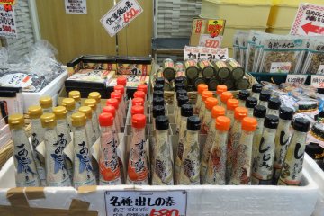 Bottles of seasoning for sale at a market stall