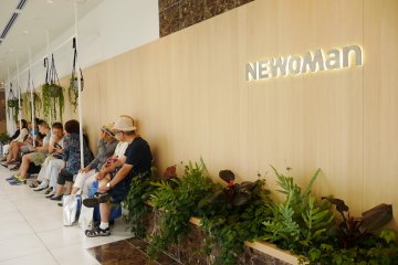 Shoppers rest to chat and admire the garden outside