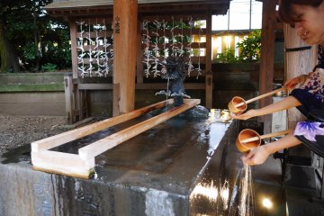 Girls cleanse their hands before praying