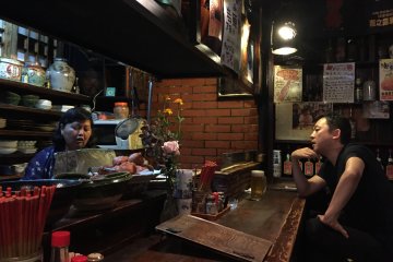 Mama-san talking to her customer