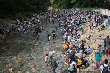Punters soaking their feet in the river