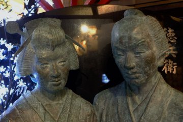 Carving of the couple - a soy sauce seller and a prostitute