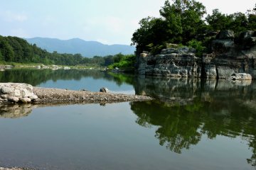 Where the river widened, the water was very still