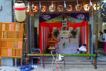 After a parade around the district, a portable shrine takes a rest