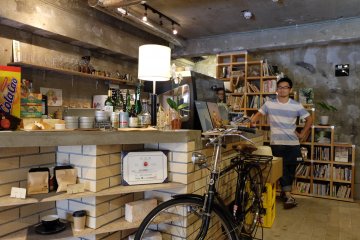 The café owner at the drinks counter