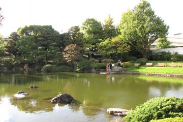 Traditional dress alongside the pond