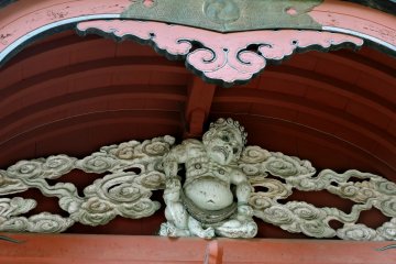 Pot-bellied figure surrounded by swirling clouds