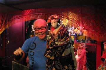 Tsujimura Juzaburo shows his famous TV puppets to his visitors