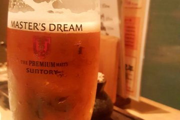 Enjoying a beer from the Nomihodai formula