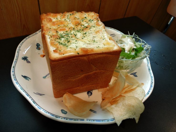Seafood gratin served in a bread case is the star of the menu