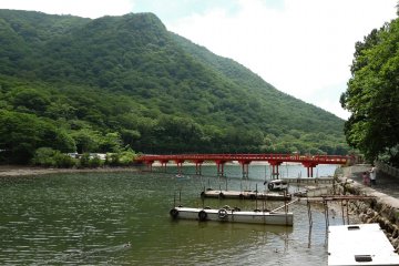 Red bridge with small jetties in the foreground