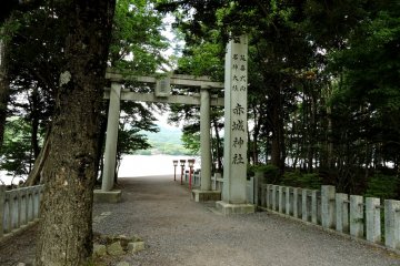 Stone torii and lanterns mark the approach to the bridge